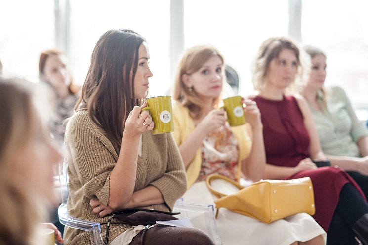 mujeres conferencia tomar cafe